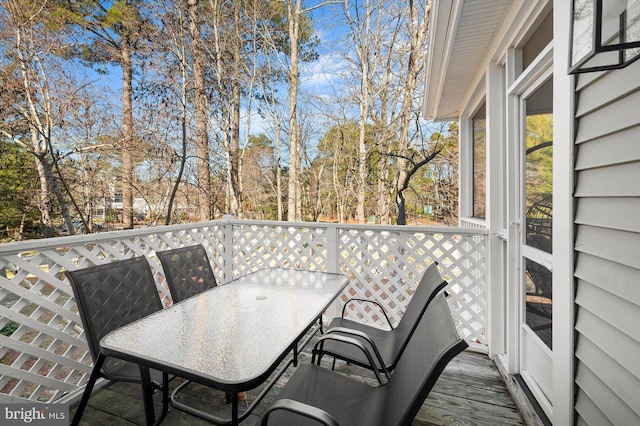 39334 Tall Pines Ct Unit 15001, Bethany Beach, DE 19930 - wooden deck with outdoor dining area and view of wooded area