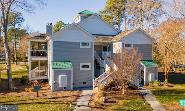 39334 Tall Pines Ct Unit 15001, Bethany Beach, DE 19930 - view of front facade featuring stairway, a balcony, a chimney, crawl space, and a metal roof