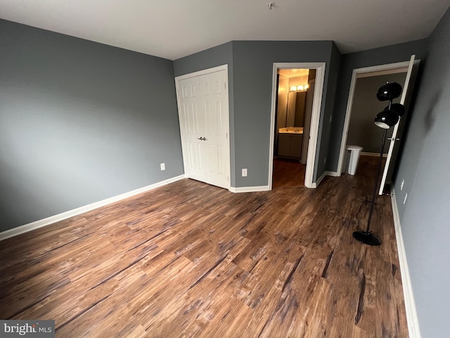 11002 Koman Cir Unit 202, Manassas, VA 20109 - unfurnished bedroom featuring dark wood-style floors and ensuite bathroom