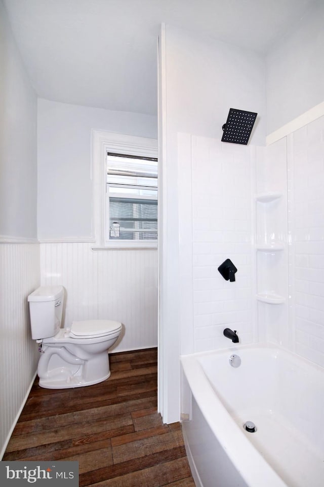 14 S 11th St, Lebanon, PA 17042 - bathroom featuring wood finished floors, tub / shower combination, and wainscoting