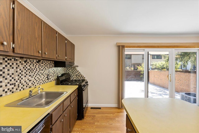 206 Canterbury Ct, Hightstown, NJ 08520 - kitchen featuring gas stove, dishwashing machine, light countertops, tasteful backsplash, and light wood-type flooring