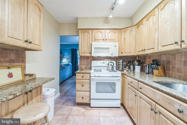 501 N Bethlehem Pike Unit 14-Q, Ambler, PA 19002 - kitchen with white appliances, light brown cabinets, light stone countertops, and decorative backsplash
