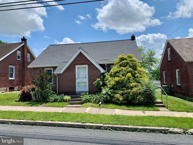 3019 Old Rte 22, Hamburg, PA 19526 - tudor house with a shingled roof, brick siding, a chimney, and a front yard
