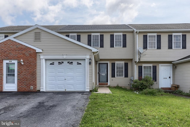 206 Lighthouse Dr, Jonestown, PA 17038 - multi unit property with asphalt driveway, an attached garage, a front lawn, and brick siding