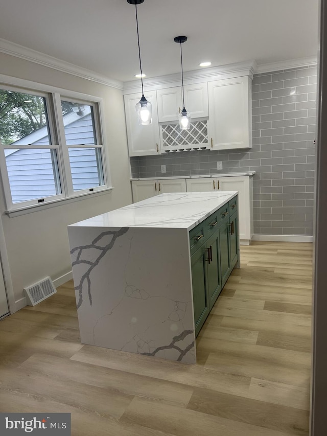 63 Baker Blvd, Marlton, NJ 08053 - kitchen featuring white cabinetry, ornamental molding, light stone counters, light wood-style flooring, and pendant lighting