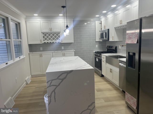63 Baker Blvd, Marlton, NJ 08053 - kitchen with stainless steel appliances, backsplash, white cabinets, crown molding, and recessed lighting