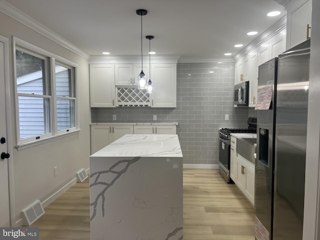 63 Baker Blvd, Marlton, NJ 08053 - kitchen featuring stainless steel appliances, white cabinetry, ornamental molding, light wood finished floors, and decorative light fixtures