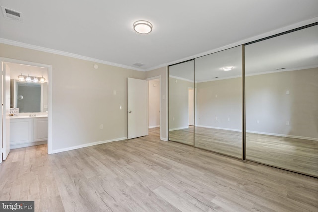 3533 Fitzhugh Ln Unit 77-A, Silver Spring, MD 20906 - unfurnished bedroom featuring ornamental molding, light wood-style floors, ensuite bathroom, and a closet