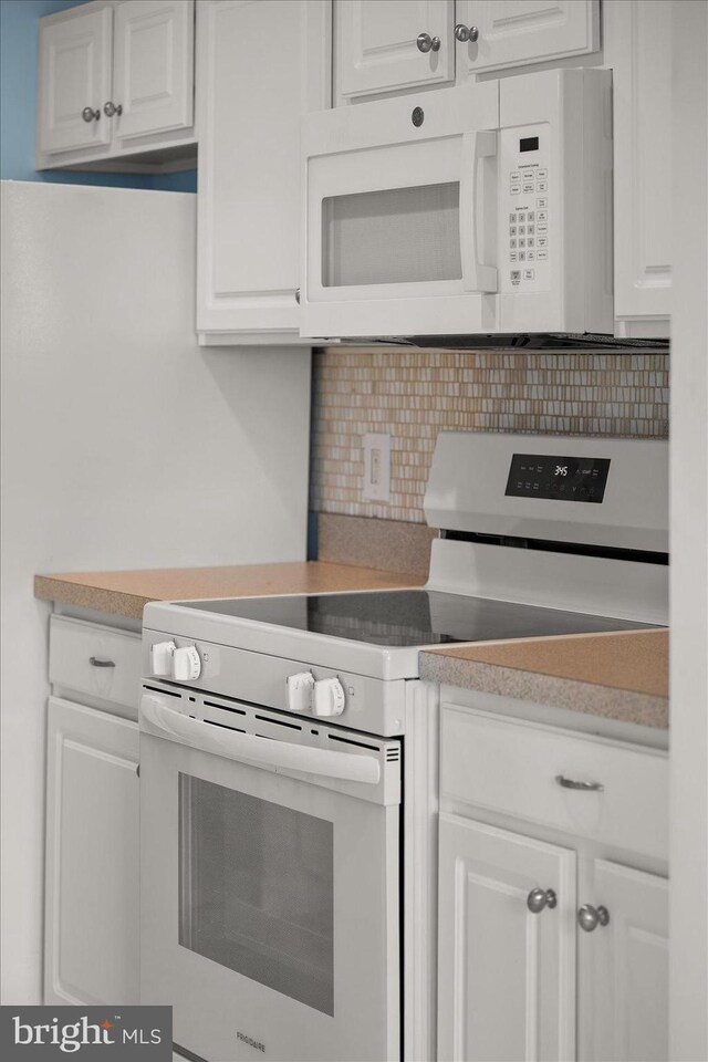 34704 Villa Cir Unit 1307, Lewes, DE 19958 - kitchen with white appliances, tasteful backsplash, white cabinets, and light countertops