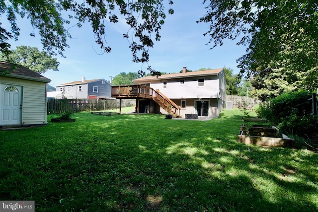 1411 Kentucky Ave, Woodbridge, VA 22191 - rear view of house with a garden, stairway, a deck, a fenced backyard, and a chimney