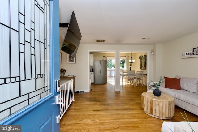 1411 Kentucky Ave, Woodbridge, VA 22191 - living area with light wood finished floors and a chandelier