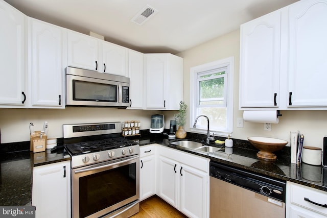 1411 Kentucky Ave, Woodbridge, VA 22191 - kitchen featuring stainless steel appliances, white cabinets, and dark stone countertops