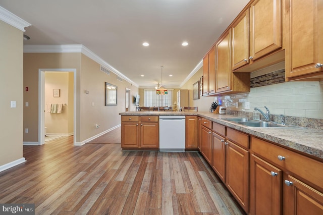 45 Harcrest Ct, Dover, DE 19901 - kitchen featuring white dishwasher, wood finished floors, crown molding, a peninsula, and brown cabinetry