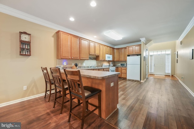 45 Harcrest Ct, Dover, DE 19901 - kitchen with white appliances, crown molding, a peninsula, dark wood-type flooring, and recessed lighting