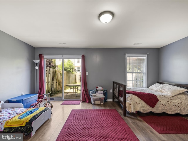 13 Mistala Ct, Inwood, WV 25428 - bedroom featuring access to outside, multiple windows, and wood finished floors
