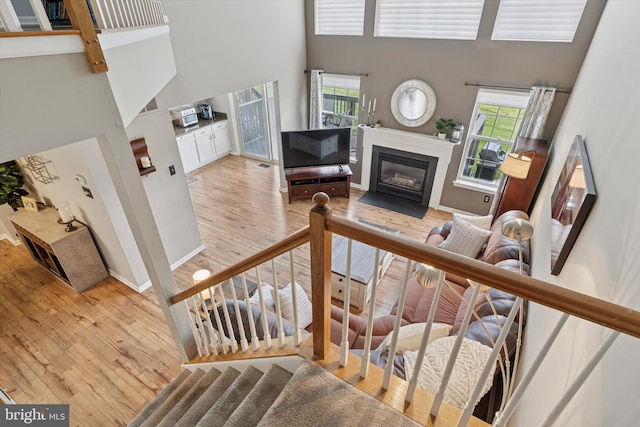 2405 Carriage Ln, Royersford, PA 19468 - stairs with a high ceiling, wood-type flooring, and a fireplace with flush hearth