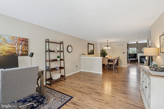 2405 Carriage Ln, Royersford, PA 19468 - office space with a chandelier, light wood-style floors, and a fireplace