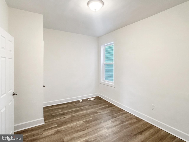 2217 Riggs Ave, Baltimore, MD 21216 - empty room with dark wood-type flooring and baseboards