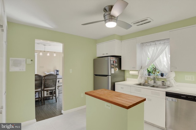 4517 Coventry Rd, Harrisburg, PA 17109 - kitchen featuring appliances with stainless steel finishes, wooden counters, white cabinets, ceiling fan, and a center island