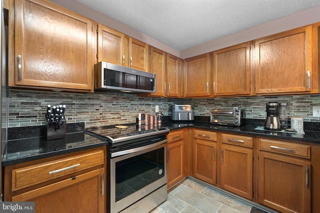 11590 Mohican Rd, Woodbridge, VA 22192 - kitchen with stainless steel appliances, decorative backsplash, and brown cabinetry