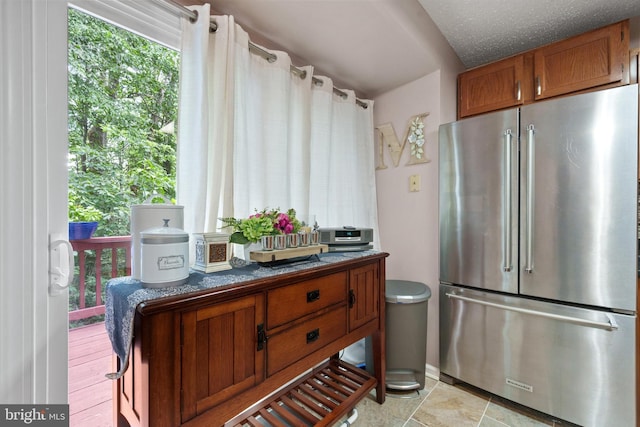 11590 Mohican Rd, Woodbridge, VA 22192 - kitchen featuring high end fridge, brown cabinets, and dark countertops