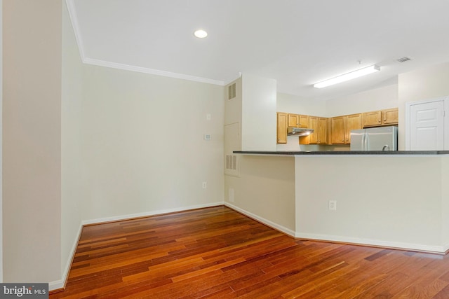 13329 Connor Dr Unit G, Centreville, VA 20120 - kitchen with freestanding refrigerator, under cabinet range hood, dark countertops, hardwood / wood-style flooring, and crown molding