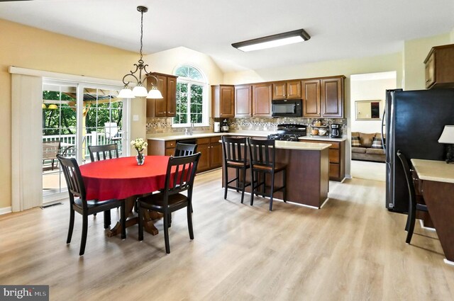 126 Fairbrook Dr, Gilbertsville, PA 19525 - dining area with light wood-style floors, lofted ceiling, and a chandelier