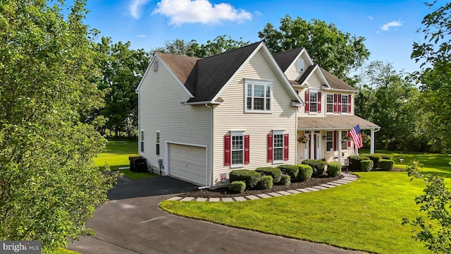 126 Fairbrook Dr, Gilbertsville, PA 19525 - traditional-style house with asphalt driveway, an attached garage, a front yard, and covered porch