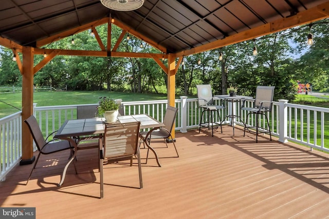 126 Fairbrook Dr, Gilbertsville, PA 19525 - wooden deck with a gazebo, outdoor dining space, a lawn, and view of scattered trees