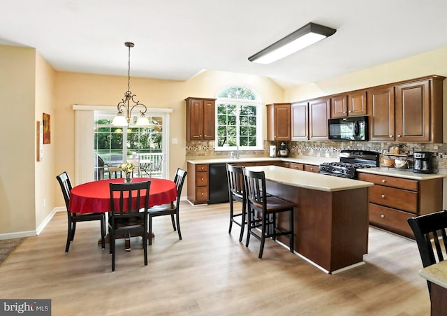 126 Fairbrook Dr, Gilbertsville, PA 19525 - kitchen featuring black appliances, light countertops, decorative backsplash, light wood-type flooring, and lofted ceiling