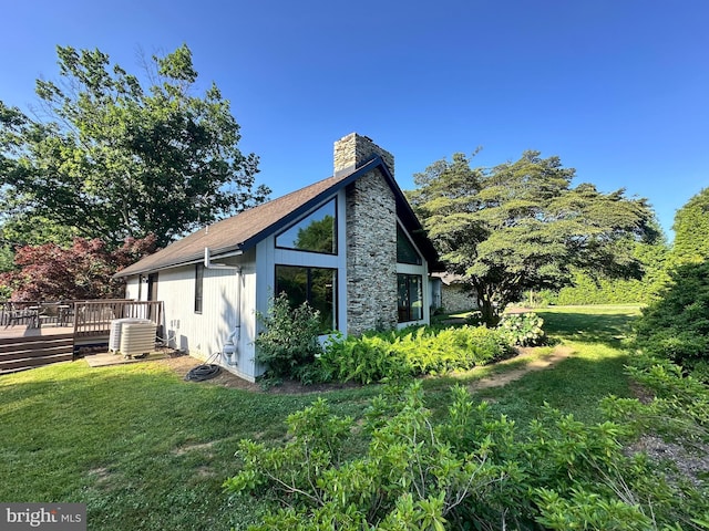 213 Tomahawk Dr, Conestoga, PA 17516 - view of home's exterior featuring a chimney, a wooden deck, and a lawn