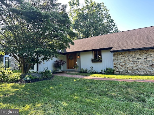 213 Tomahawk Dr, Conestoga, PA 17516 - view of front of home featuring a front lawn, roof with shingles, and stone siding
