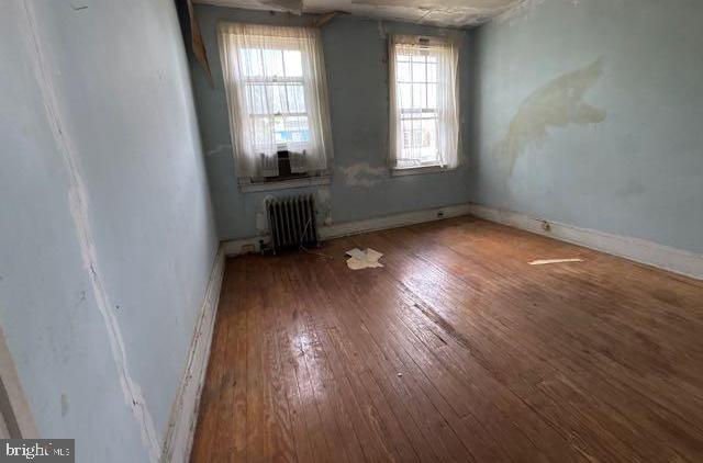 3953 Wilsby Ave, Baltimore, MD 21218 - spare room with radiator heating unit and hardwood / wood-style flooring