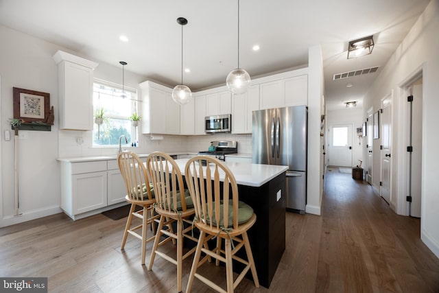 3426 Main St, Morgantown, PA 19543 - kitchen featuring stainless steel appliances, a center island, decorative backsplash, light countertops, and a breakfast bar