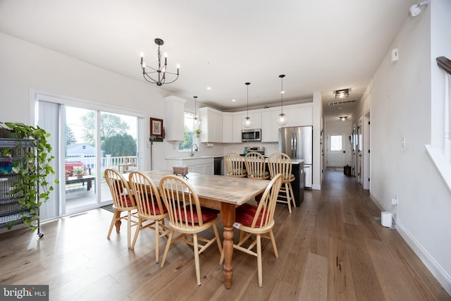 3426 Main St, Morgantown, PA 19543 - dining space featuring light wood finished floors, healthy amount of natural light, and a chandelier