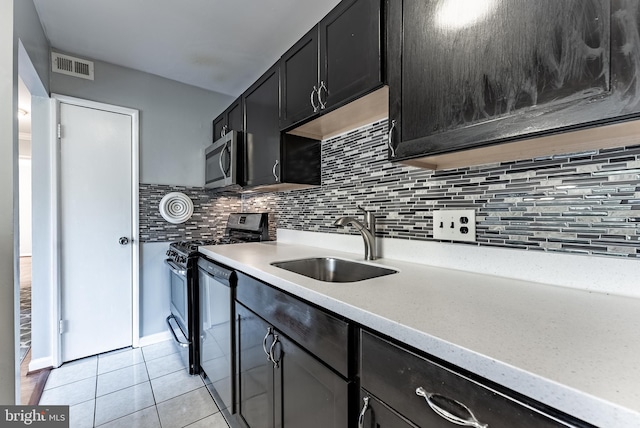 2908 Kings Chapel Rd Unit 03/12, Falls Church, VA 22042 - kitchen featuring appliances with stainless steel finishes, light tile patterned flooring, backsplash, light countertops, and dark cabinetry