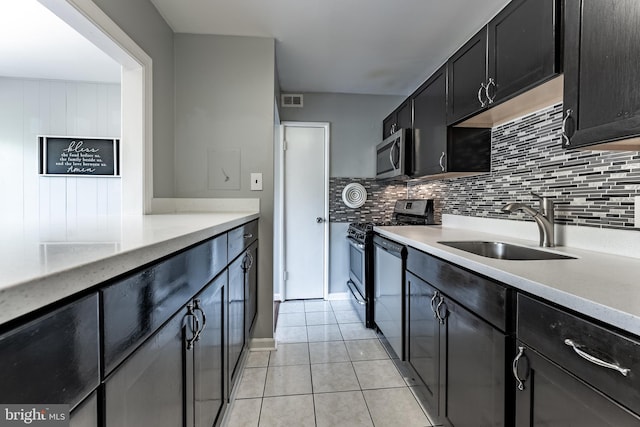 2908 Kings Chapel Rd Unit 03/12, Falls Church, VA 22042 - kitchen with stainless steel appliances, light tile patterned floors, decorative backsplash, light countertops, and dark cabinets
