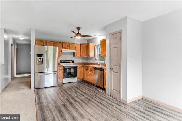 3189 Horseshoe Pike, Honey Brook, PA 19344 - kitchen featuring appliances with stainless steel finishes, under cabinet range hood, a ceiling fan, and light wood finished floors