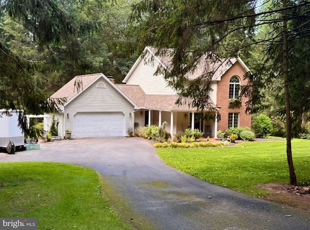 4018 Hillview Rd, Temple, PA 19560 - view of front facade with asphalt driveway, an attached garage, a front lawn, covered porch, and a shingled roof