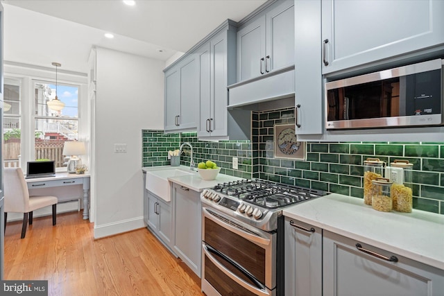 1425 Webster St NW, Washington, DC 20011 - kitchen with stainless steel appliances, gray cabinetry, light wood-style flooring, decorative backsplash, and recessed lighting