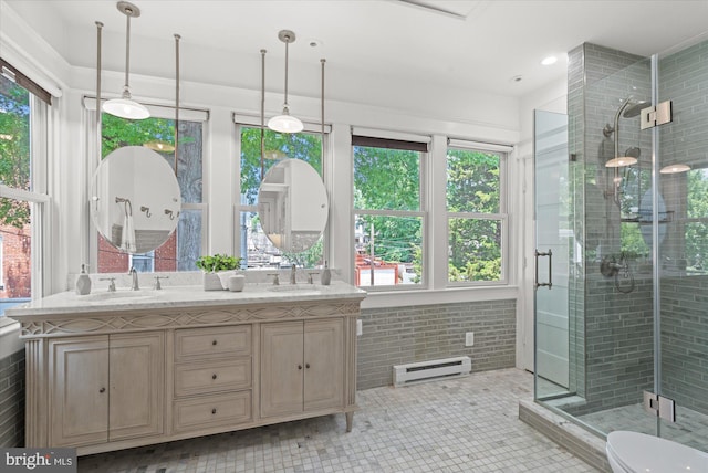 1425 Webster St NW, Washington, DC 20011 - bathroom with a baseboard heating unit, double vanity, and plenty of natural light