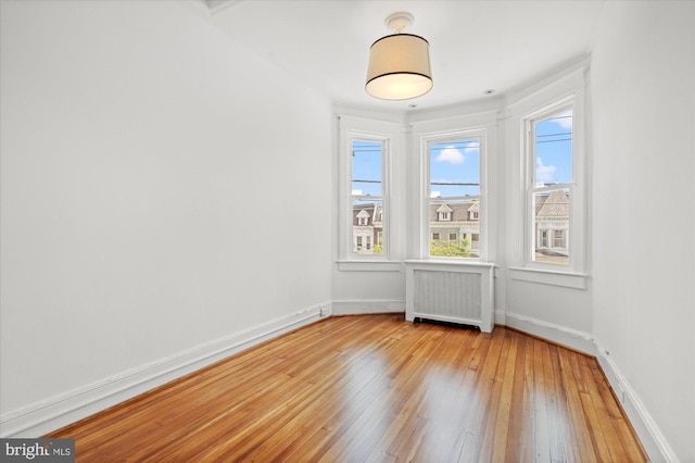 1425 Webster St NW, Washington, DC 20011 - empty room featuring radiator and light wood finished floors