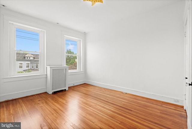 1425 Webster St NW, Washington, DC 20011 - spare room featuring radiator heating unit and light wood-style flooring