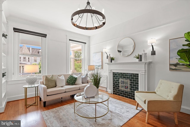 1425 Webster St NW, Washington, DC 20011 - living area featuring wood finished floors, a chandelier, and a tile fireplace