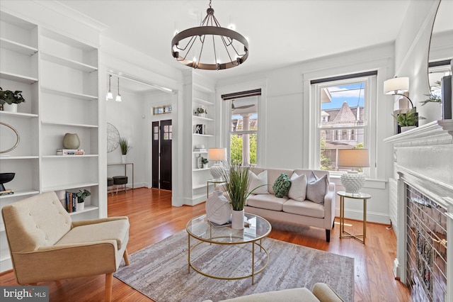 1425 Webster St NW, Washington, DC 20011 - living room with built in features, a chandelier, wood finished floors, and a fireplace
