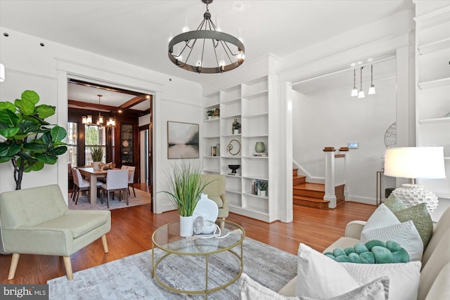 1425 Webster St NW, Washington, DC 20011 - living area featuring a chandelier, wood finished floors, stairs, built in features, and crown molding