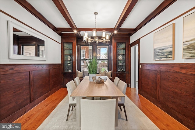 1425 Webster St NW, Washington, DC 20011 - dining room with a chandelier, wooden walls, wood finished floors, beam ceiling, and coffered ceiling