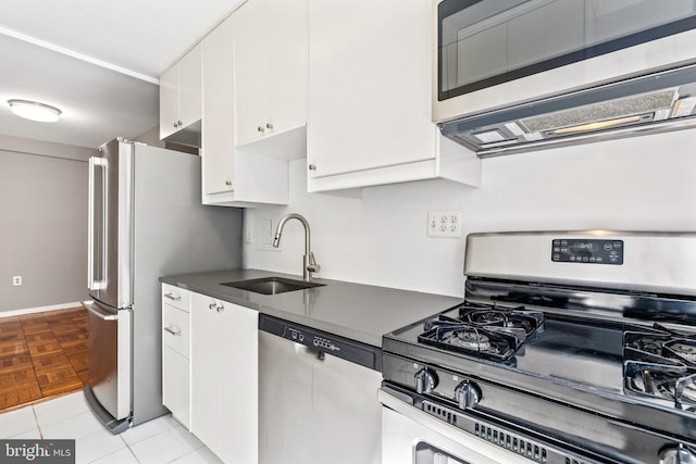 4100 W St NW Unit 306, Washington, DC 20007 - kitchen featuring stainless steel appliances, dark countertops, and white cabinets