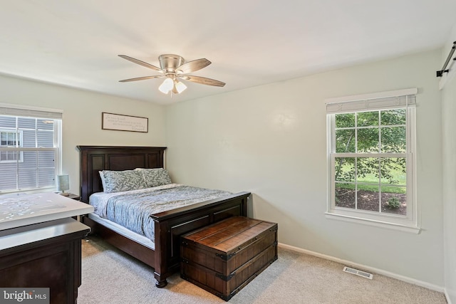 8535 Dark Hawk Cir, Columbia, MD 21045 - bedroom featuring carpet, a barn door, and ceiling fan