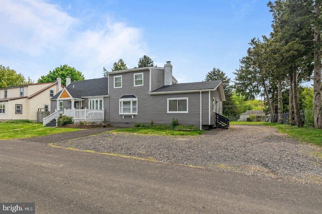 1039 Clinton Ave, Bensalem, PA 19020 - view of front of property with a chimney, a deck, crawl space, and a shingled roof
